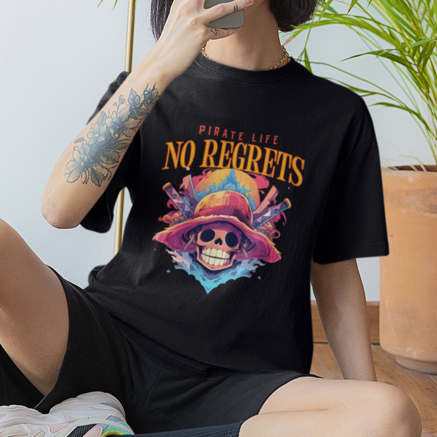Female model in a black oversized Pirate Life T-Shirt featuring an anime graphic