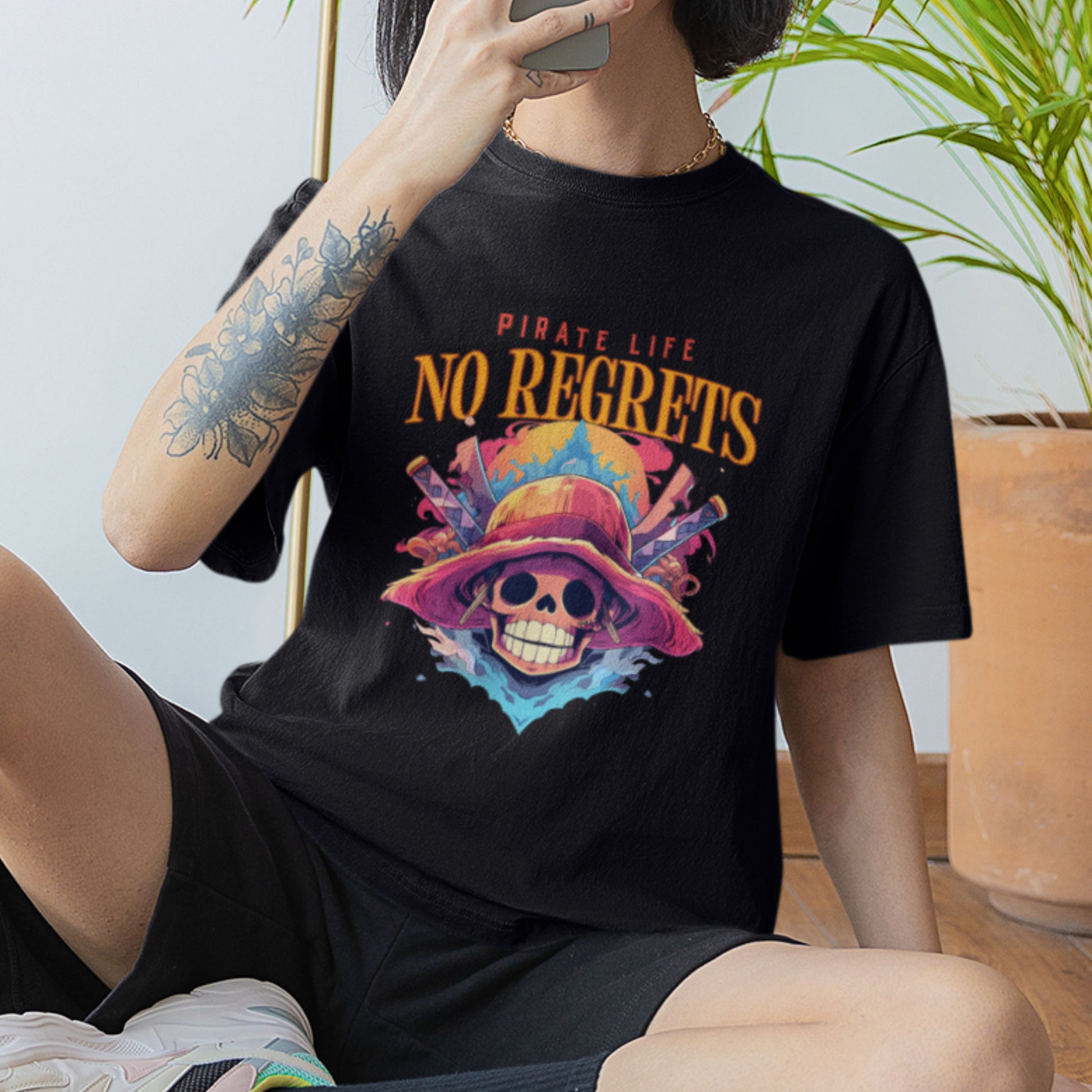 Female model in a black oversized Pirate Life T-Shirt featuring an anime graphic